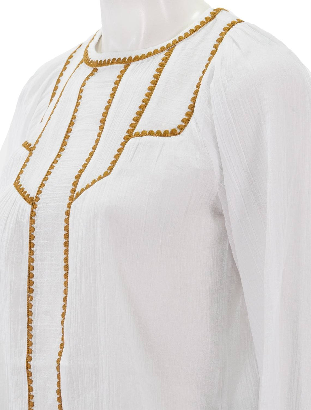 Close-up view of Scotch & Soda's white patchwork bib blouse with embroidery.