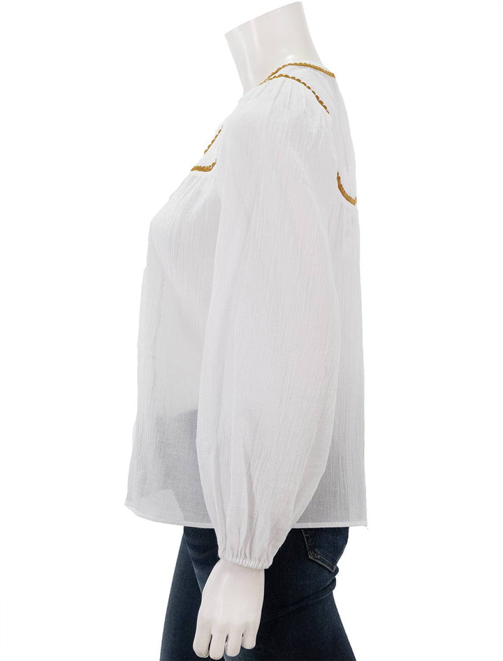 Side view of Scotch & Soda's white patchwork bib blouse with embroidery.