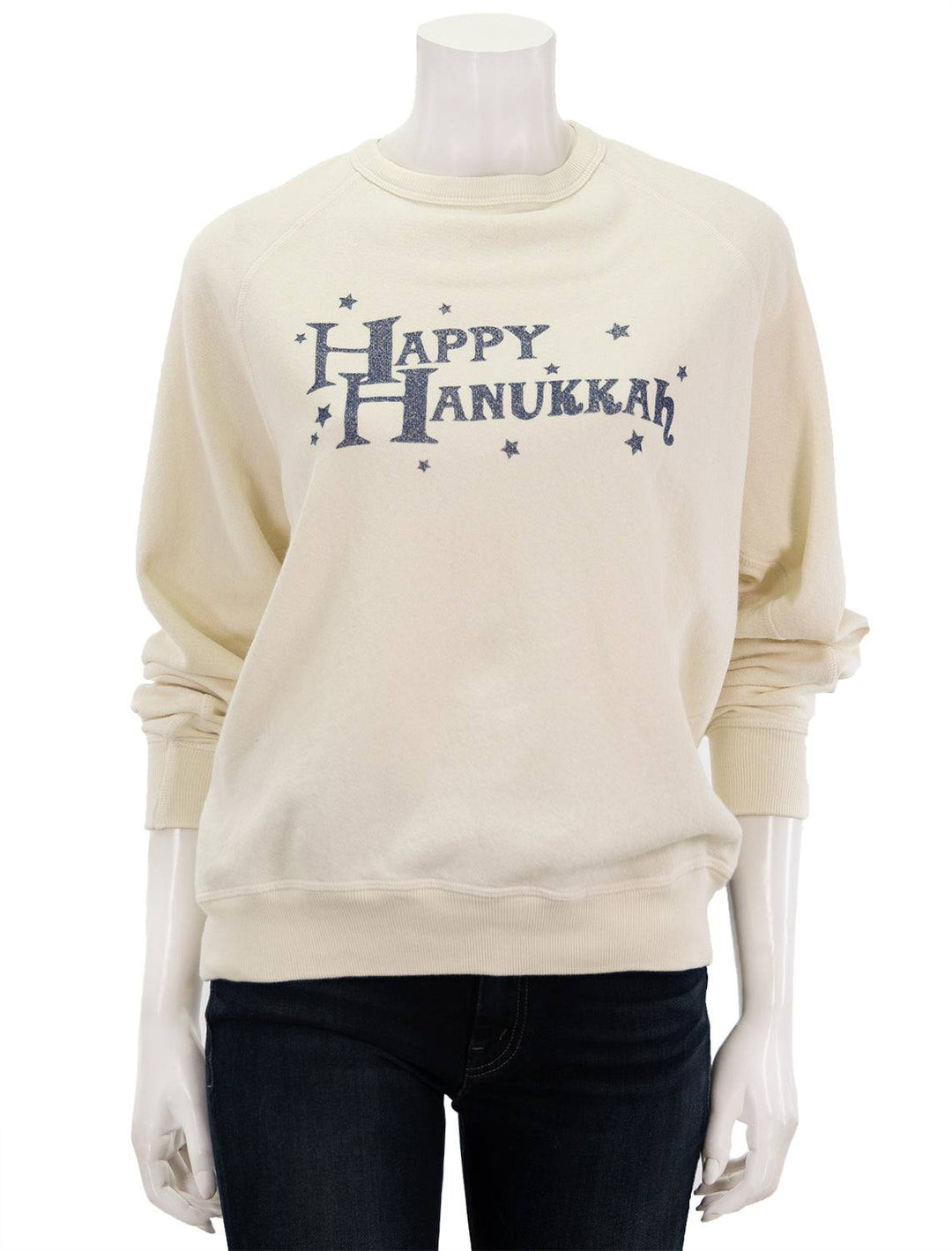 Front view of The Great's happy hanukkah college sweatshirt in washed white.