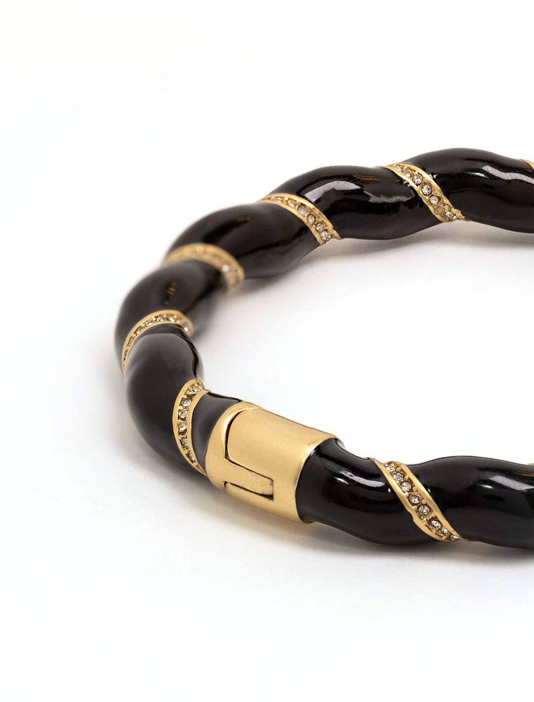 Close-up view of Clare V.'s enamel rope bangle in black.