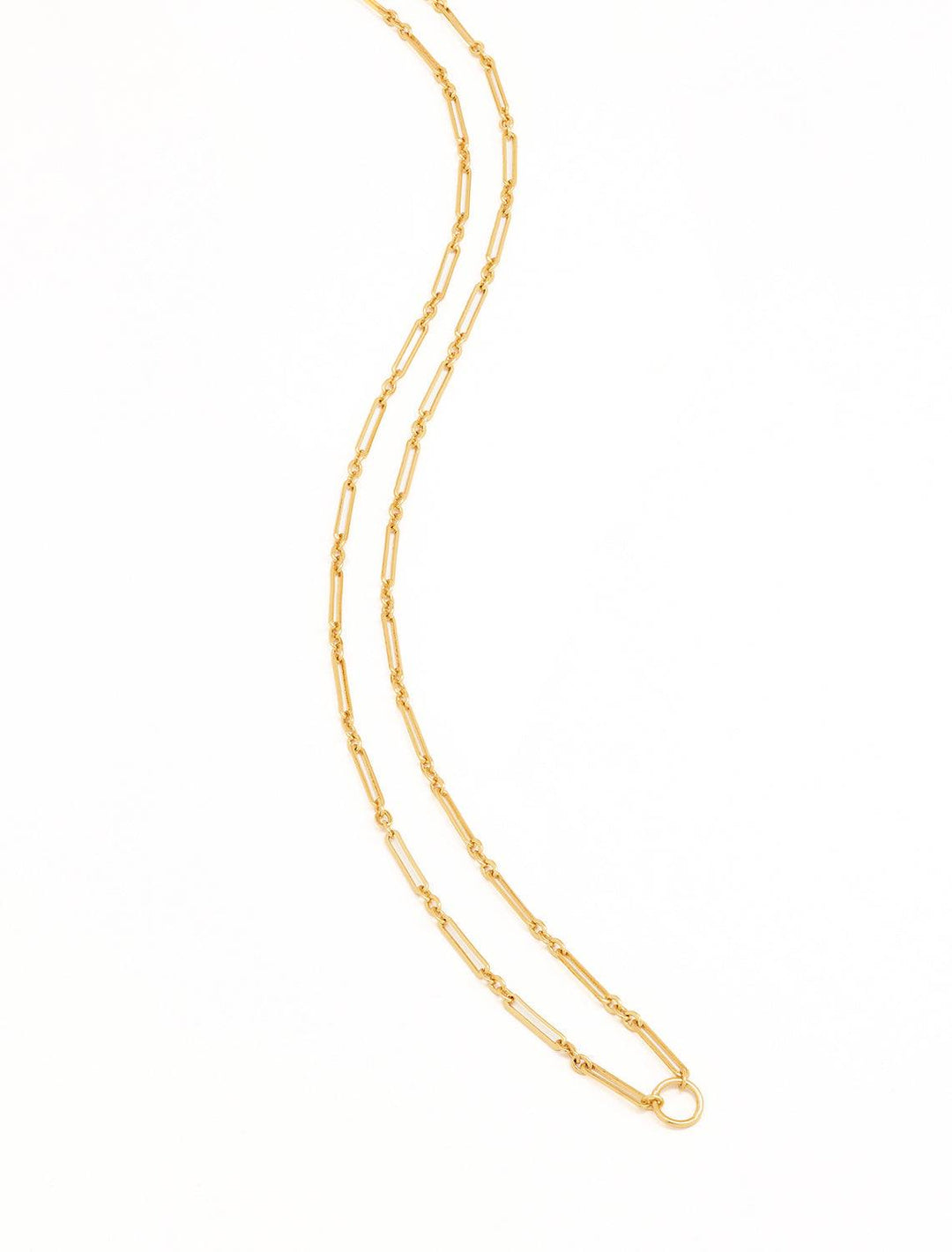 Stylized laydown of Clare V.'s paperclip chain necklace in vintage gold.