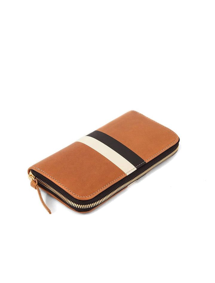 Overhead view of Clare V.'s zip wallet in vachetta and black and cream stripe.