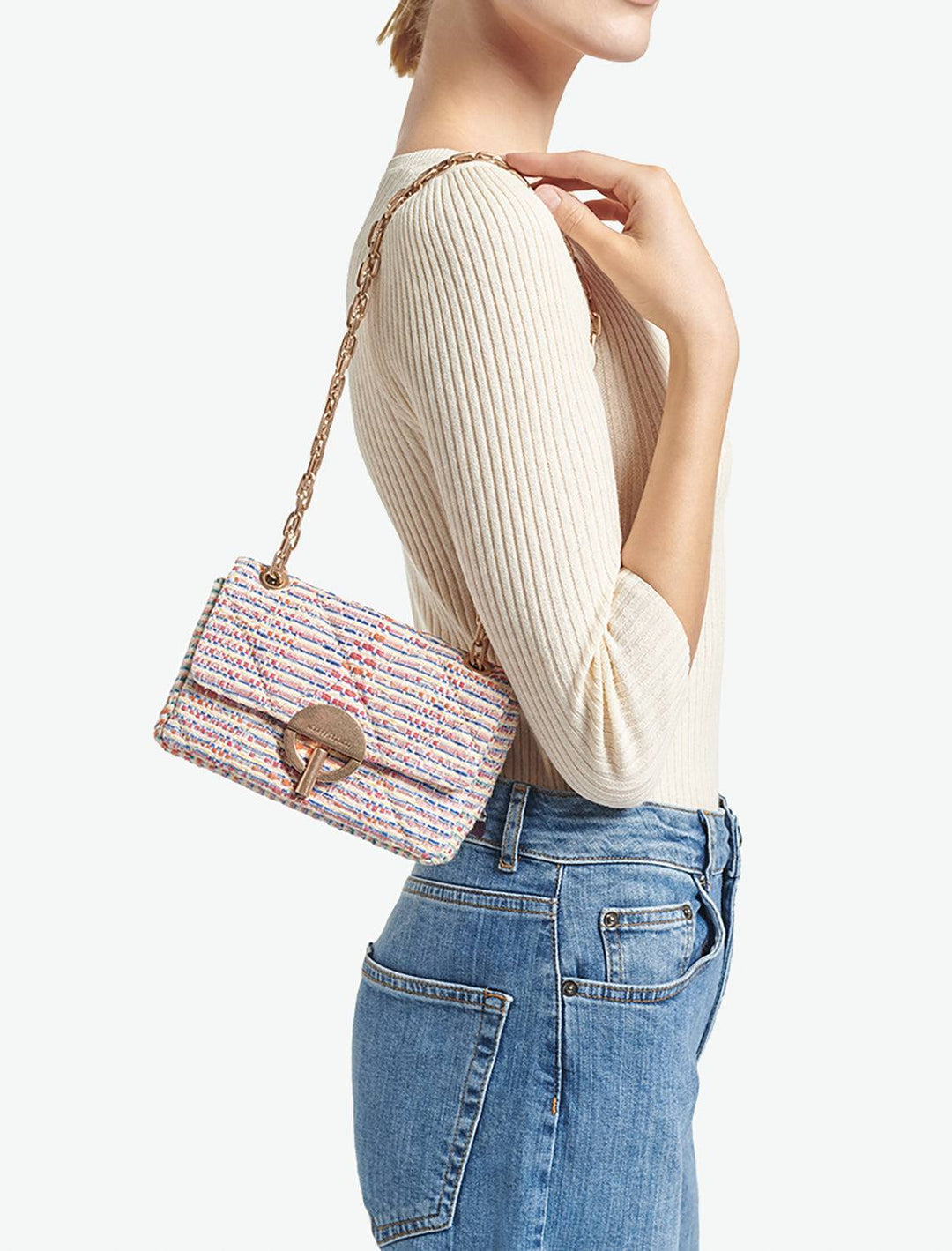 Model wearing Vanessa Bruno's moon nano bag in multi.
