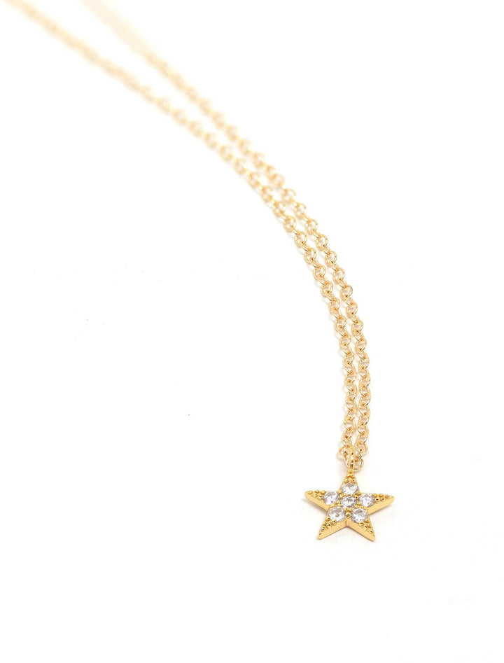 Kris Nations' star crystal charm necklace in gold.