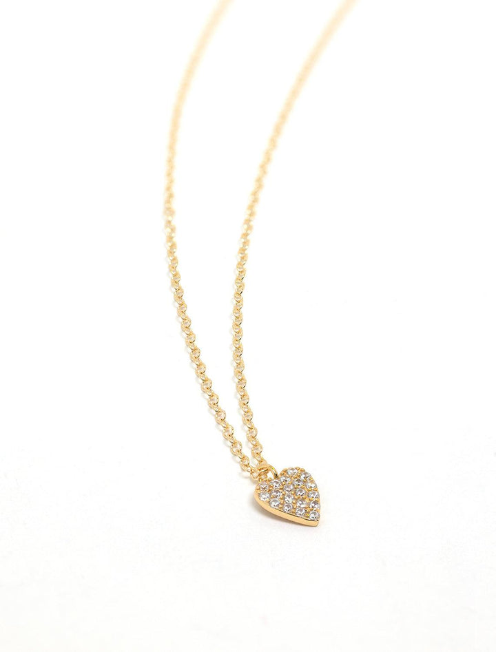 Kris Nations' heart crystal charm necklace in gold.