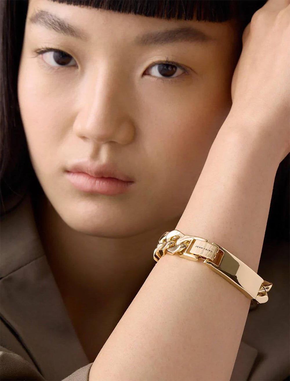 Model wearing Jenny Bird's Bo Bracelet in Gold Tone Dipped Brass.
