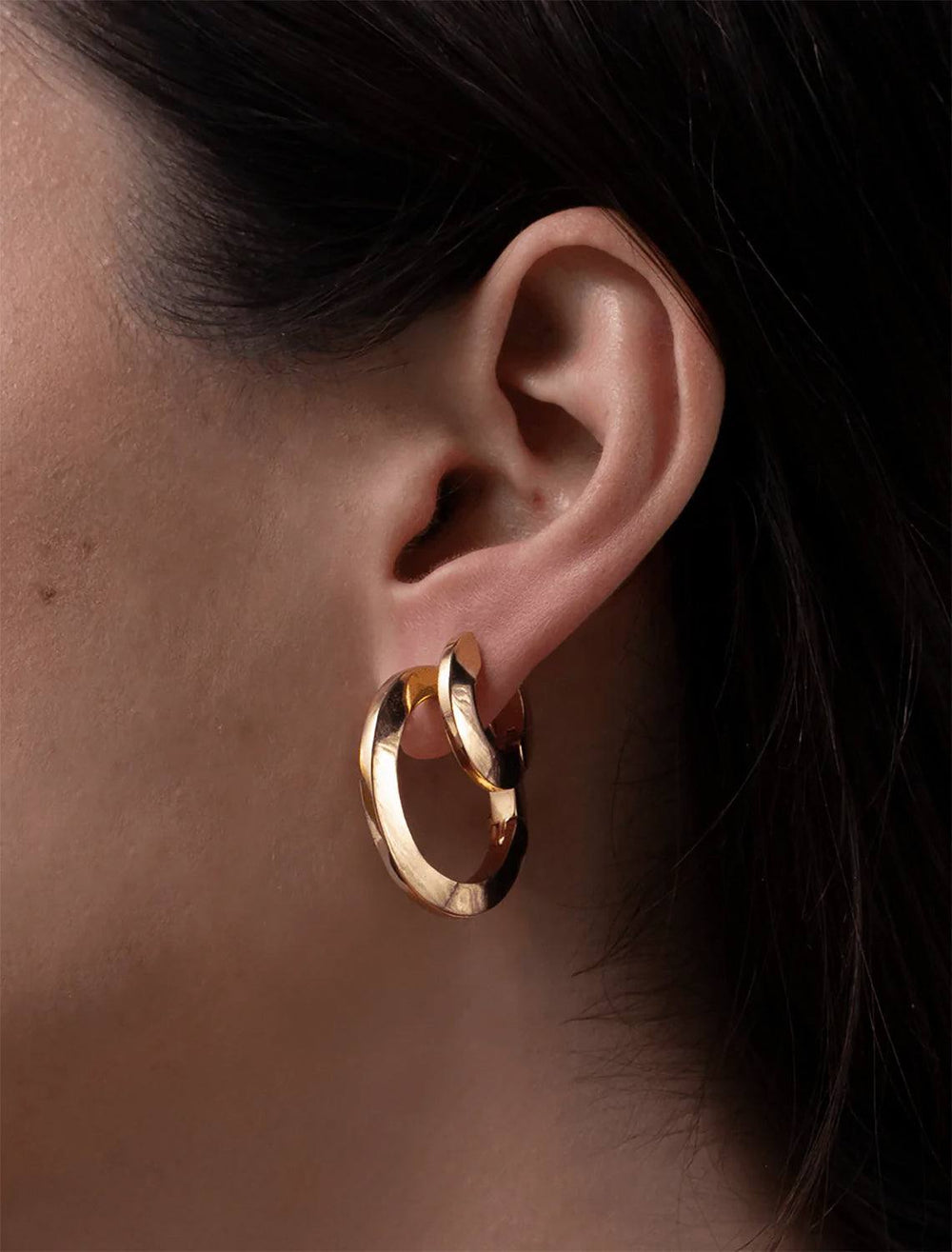Model wearing Jenny Bird's Toni Hinged Hoop Earrings in 14K Gold-Dipped Brass.