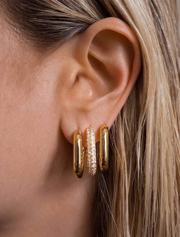 Model wearing Luv AJ's xl chain link hoops in gold.
