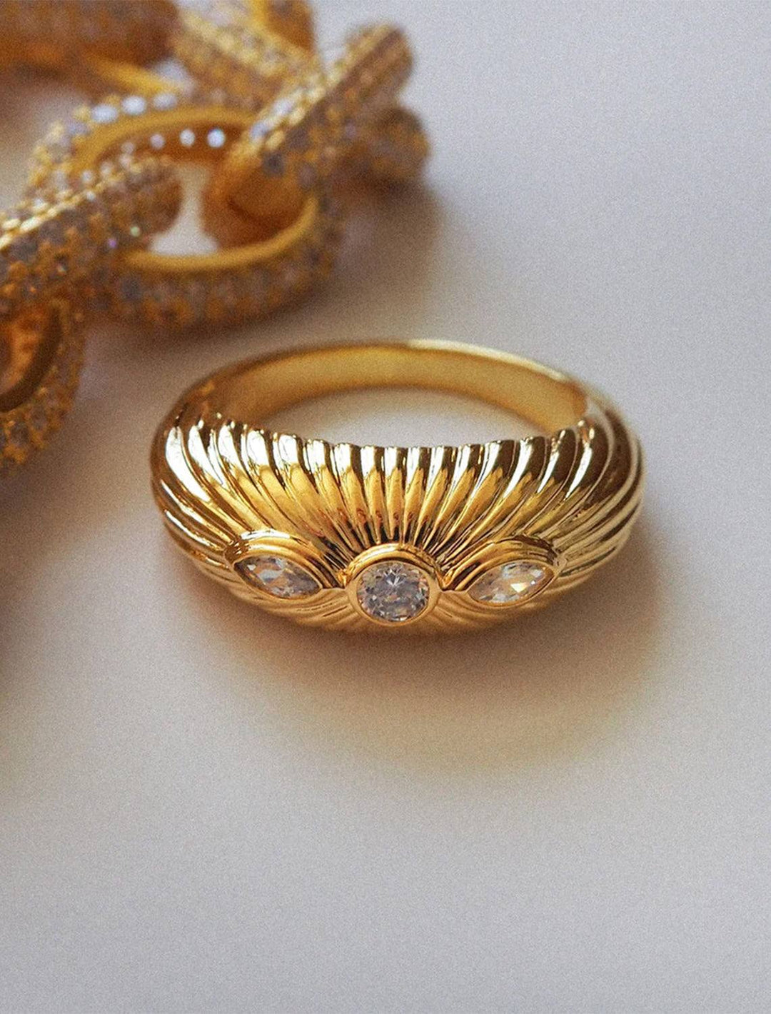 Stylized laydown of Luv AJ's florette ridged signet ring in gold