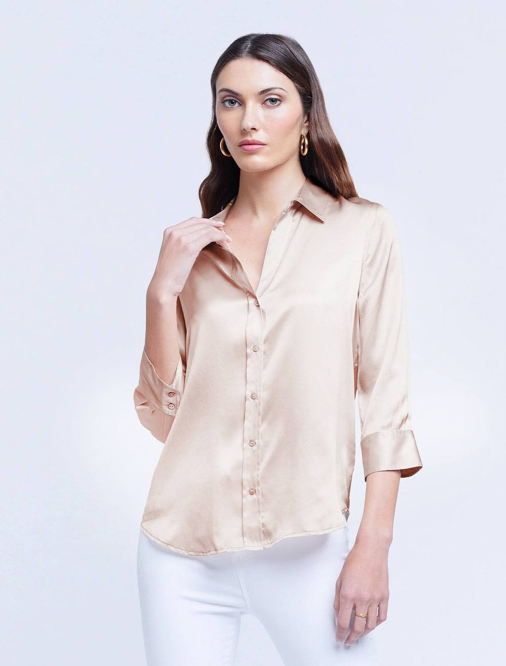 model wearing dani blouse in champagne with white pants