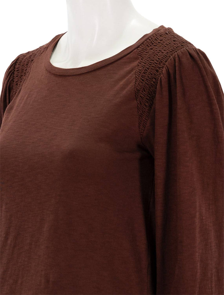 Close-up view of Sundry's smocked shoulder top in wine.