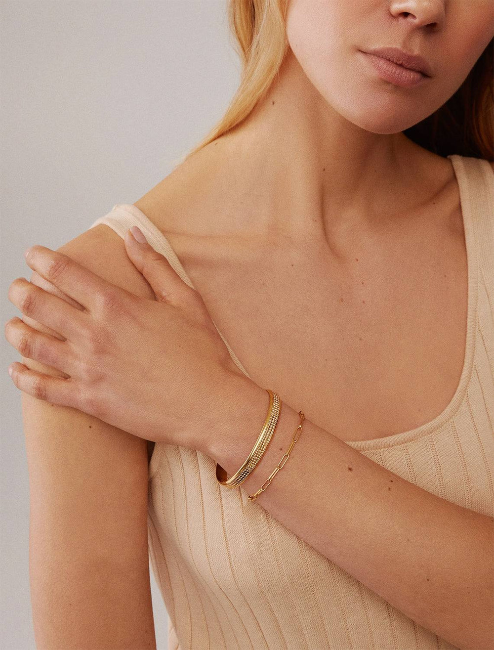 Model wearing Anna Beck's Classic Wide Band Stacking Cuff in Gold.