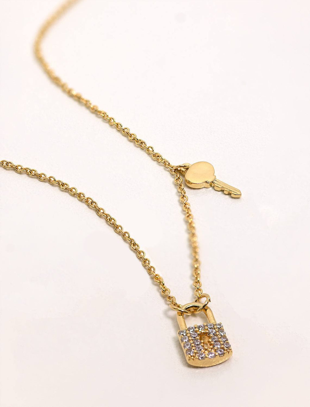Tai jewelry's pave cubic zirconia lock and key necklace in gold.