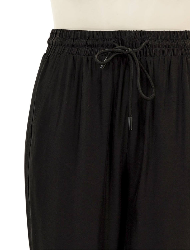 Close-up view of ATM's wide leg silk pant in black.