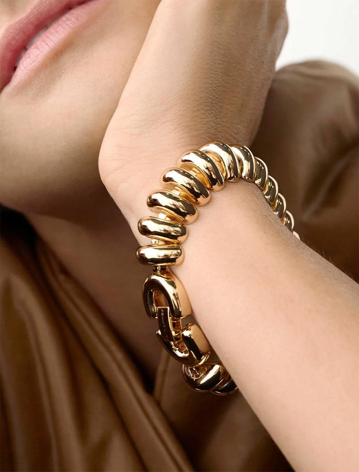 Model wearing Jenny Bird's Sofia Mega Bracelet in Gold Tone Dipped Brass.