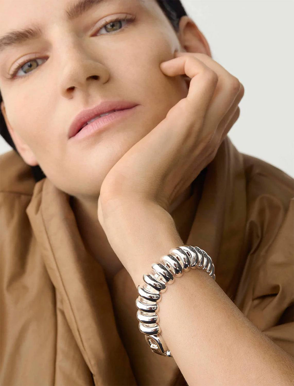 Model wearing Jenny Bird's Sofia Mega Bracelet in Silver Dipped Brass.