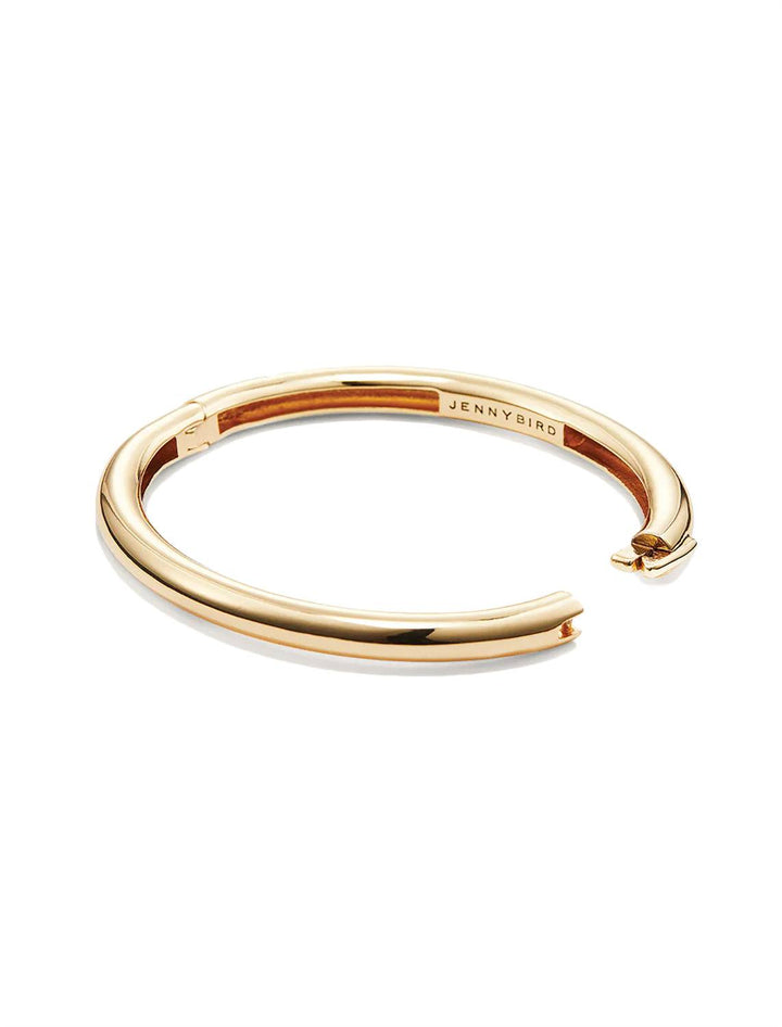 Side view of Jenny Bird's Gia Bangle in Gold Tone Dipped Brass, with the clasp open.