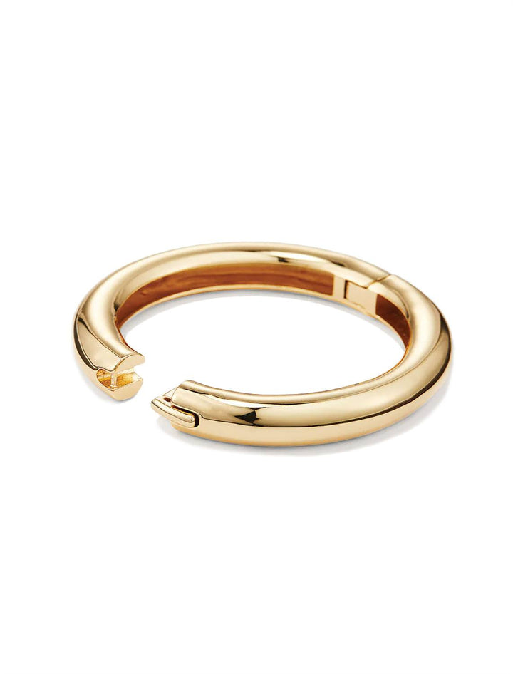 Side angle view of Jenny Bird's Gia Mega Bangle in Gold Tone Dipped Brass, with the clasp open.