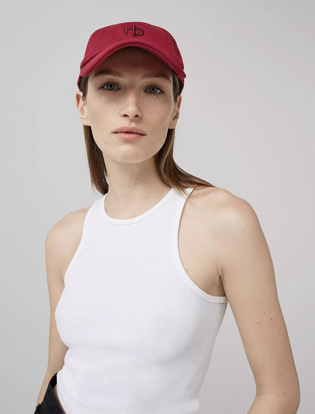 Model wearing Rag & Bone's aron baseball cap in biking red.