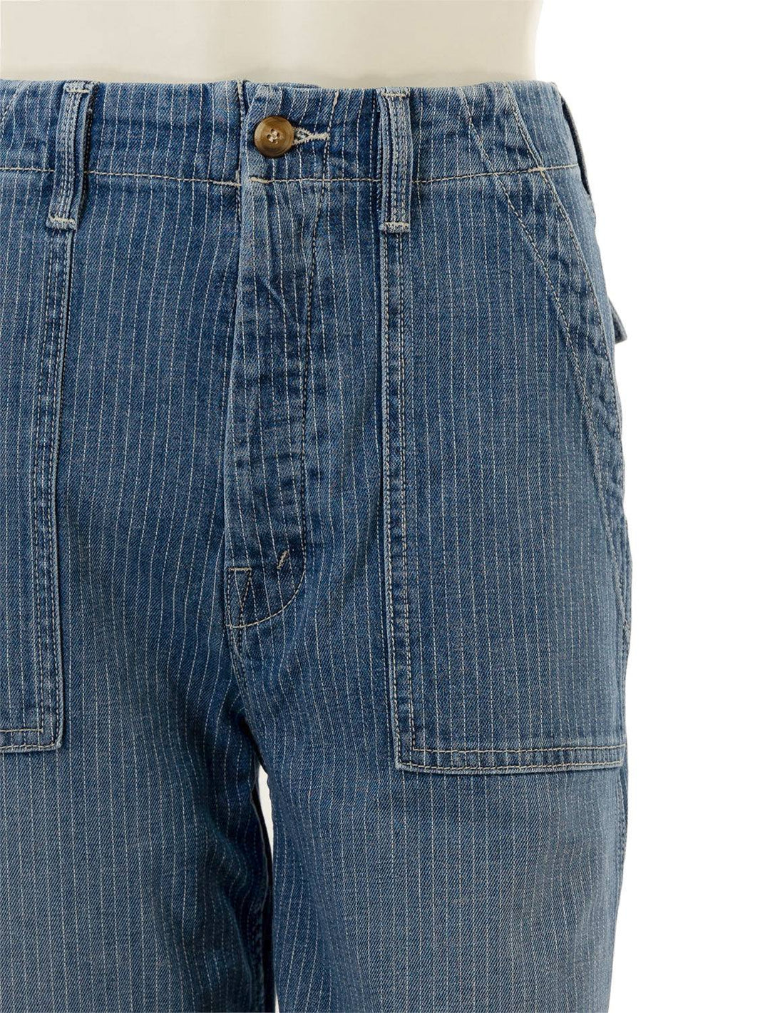 Close-up view of Mother Denim's patch pocket ankle fray in on the right track.