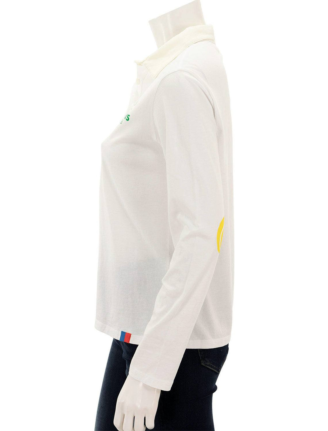 Side view of KULE's the tennis elbow polo in white.
