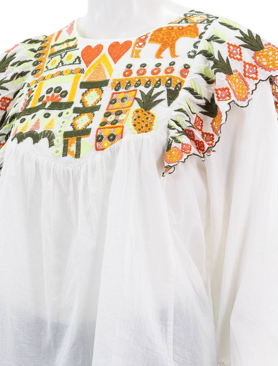Close-up view of Farm Rio's embroidery fall leaf white blouse.