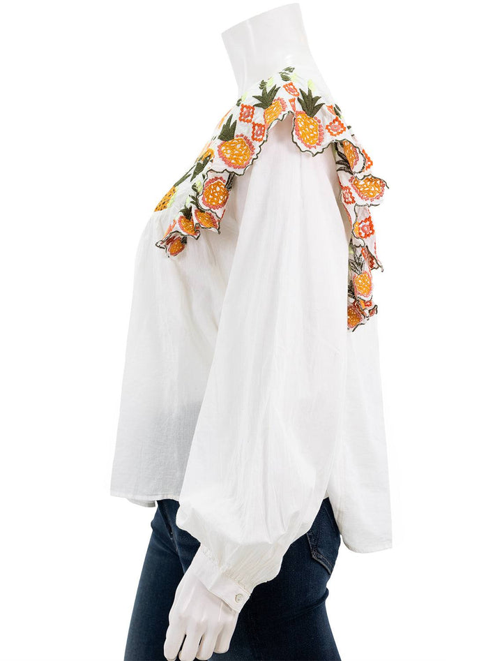 Side view of Farm Rio's embroidery fall leaf white blouse.