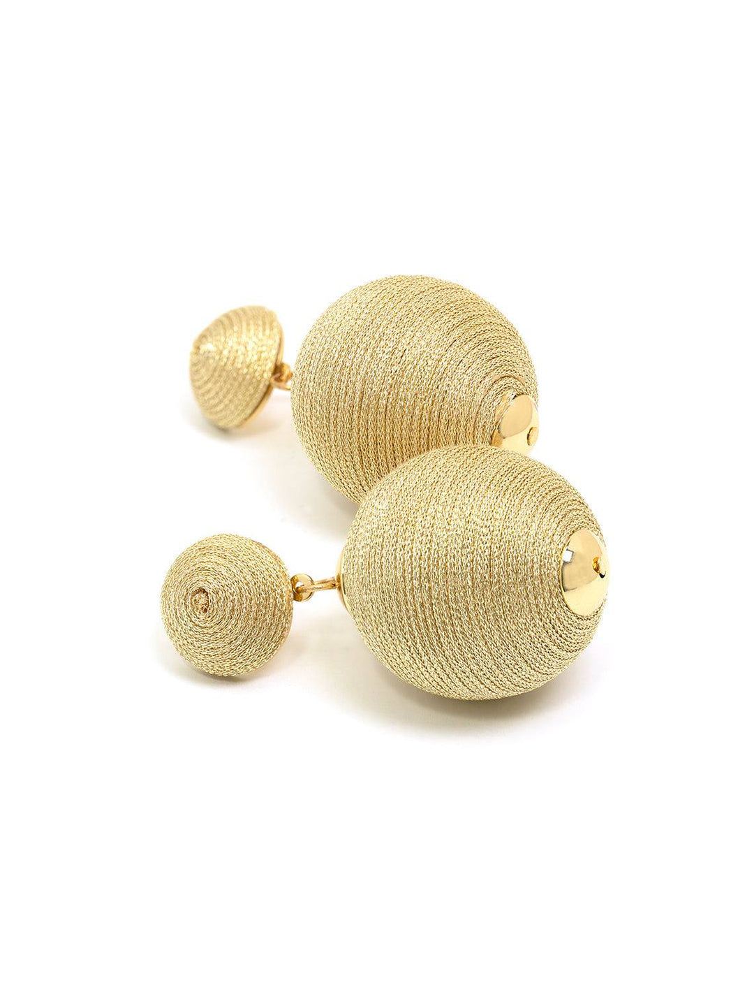 Stylized laydown of St. Armand's gold metallic lido pom poms.