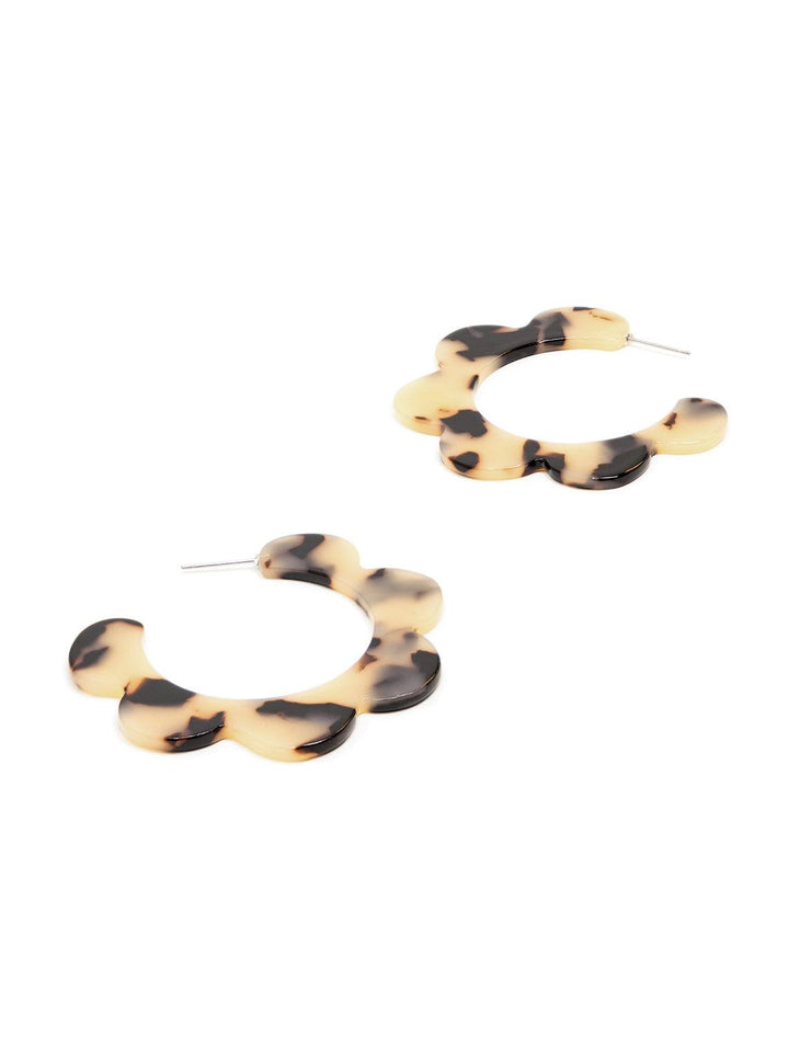 Overhead view of St. Armand's blonde tortoise scalloped hoops.