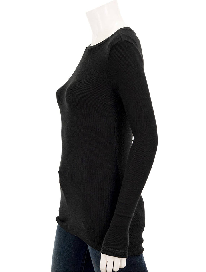 Side view of Goldie Lewinter's ribbed long sleeve tee in black.