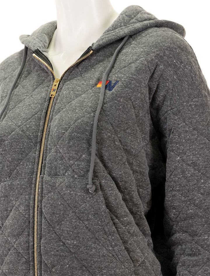 Close-up view of Aviator Nation's quilted zip hoodie relaxed in heather grey.