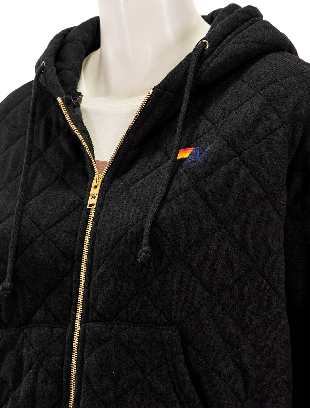 Close-up view of Aviator Nation's quilted zip hoodie relaxed in black.