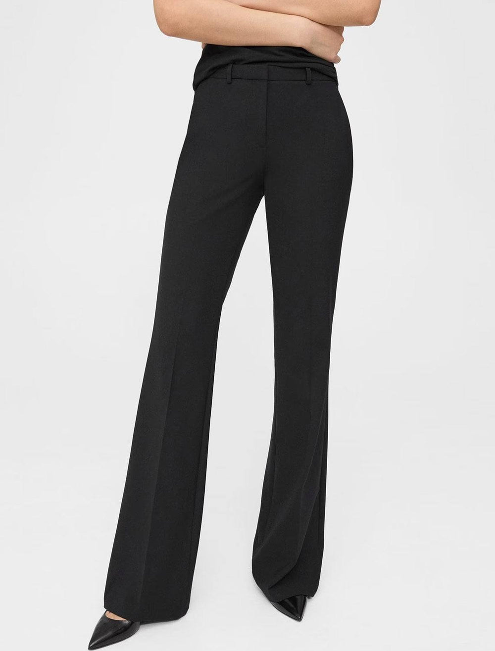 Model wearing Theory's demetria traceable wool trousers in black.