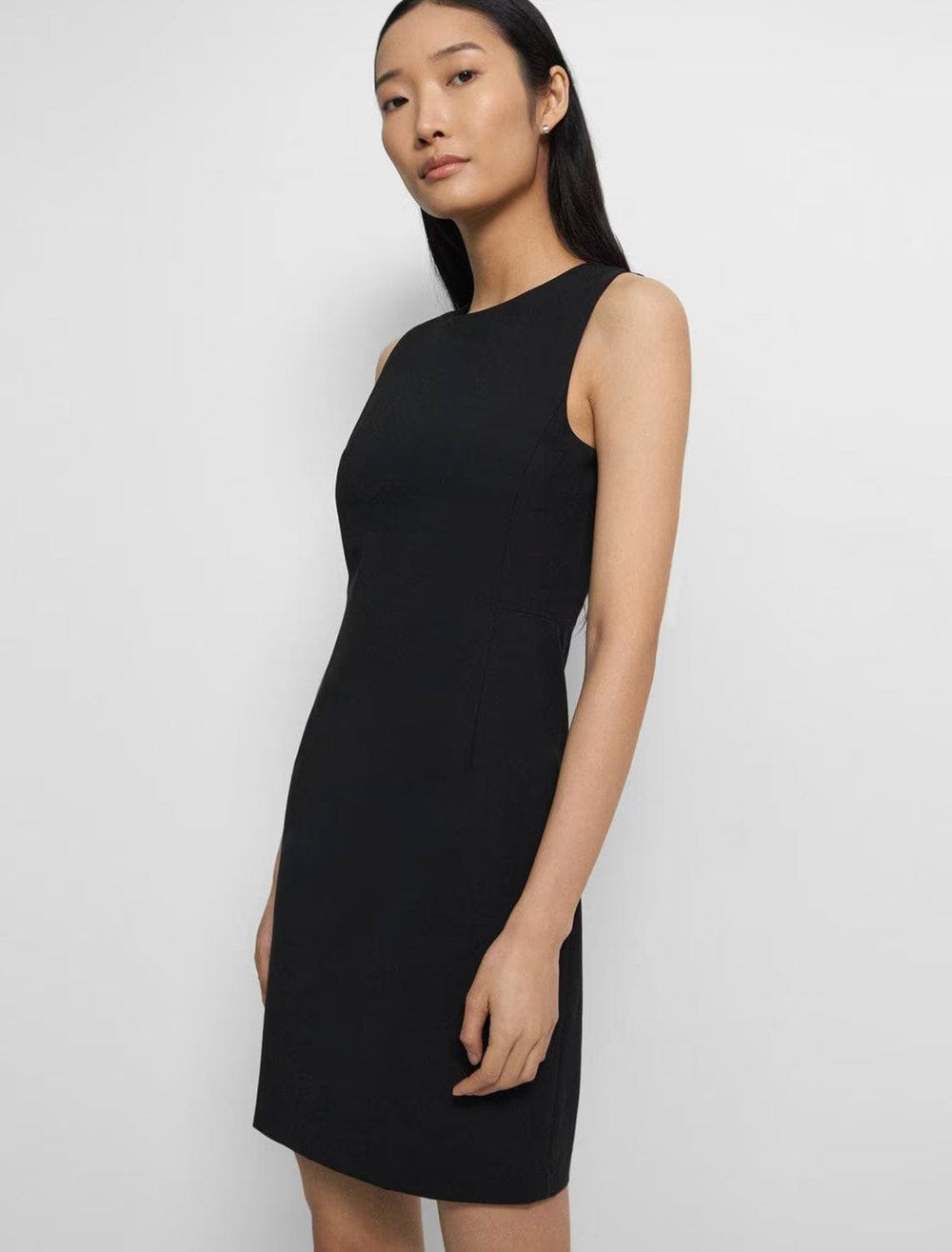 Model wearing Theory's sleeveless fitted dress in traceable wool.