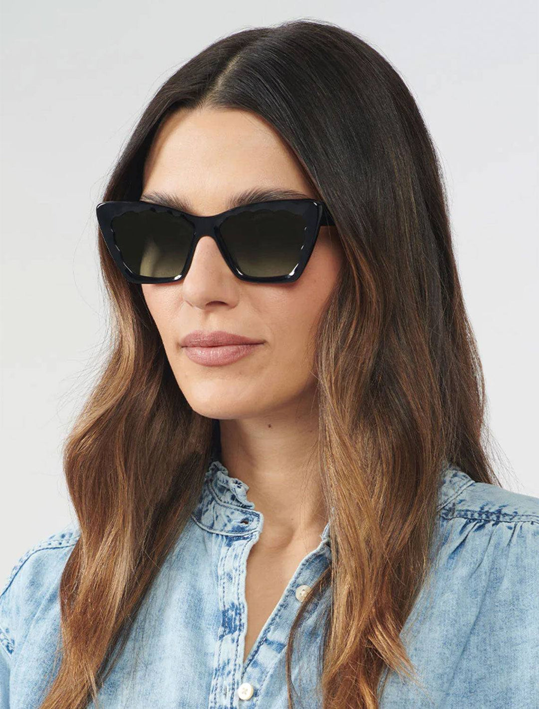Model wearing Krewe's brigitte sunglasses in black and black crystal.