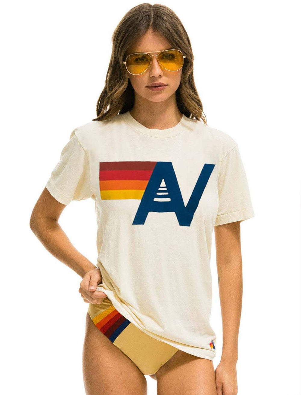 Model wearing Aviator Nation's logo crew tee shirt in vintage white.